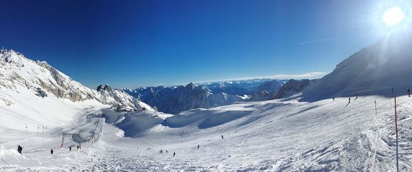 Scenic view of snowcapped mountains against clear blue sky