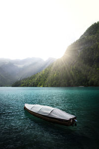 Boat in lake against sky