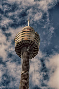 Low angle view of tower against cloudy sky