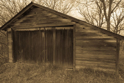 Wooden house with house in background