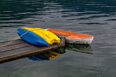 Boats moored at pier on river