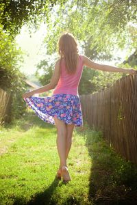 Rear view of woman standing on field