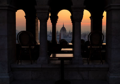 Hungarian parliament building seen through window during sunset in city