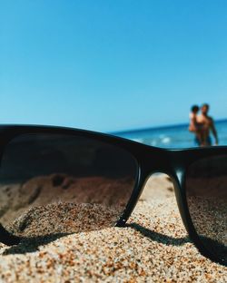 Man on beach against clear sky