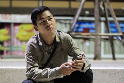 A man standing in the park at night.