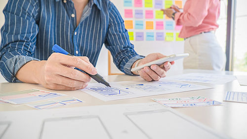 Midsection of people working on table