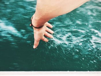 Low section of woman swimming in sea