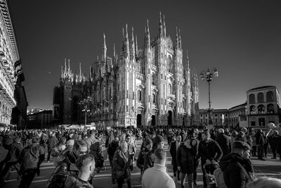 Group of people in front of buildings in city