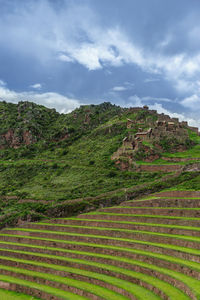 Scenic view of mountain against cloudy sky