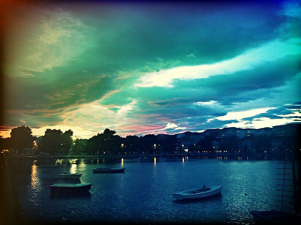 SAILBOATS IN LAKE AT SUNSET