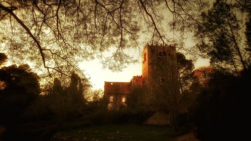 Low angle view of built structure at sunset