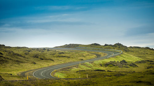 Scenic view of winding road against sky