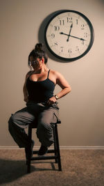 Young woman sitting on chair at home