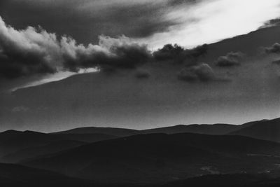 Scenic view of silhouette mountains against sky at dusk