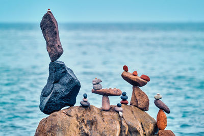 Close-up of rocks on shore against sea