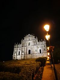 Low angle view of building lit up at night