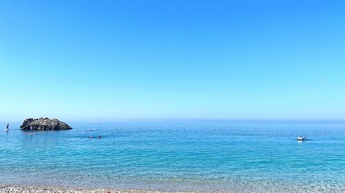 Scenic view of sea against clear blue sky