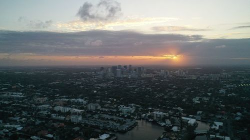 High angle view of city buildings against sky during sunset