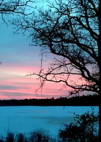 Scenic view of lake against sky at sunset