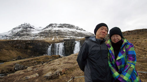 Full length of woman standing on mountain against sky