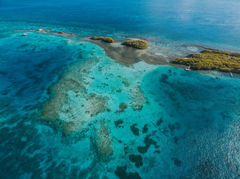 High angle view of rocks on sea shore
