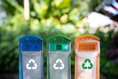 Close-up of garbage cans with recycling symbol