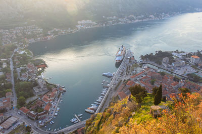 Top view of boko-kotor bay at sunset. houses with red tiles, boats, launches and a cruise liner