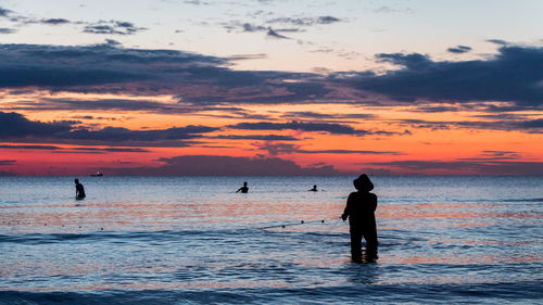 A fisherman is fishing at sunset on koh rong, cambodia