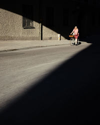 Man riding bicycle on road