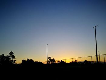 Silhouette trees against sky during sunset