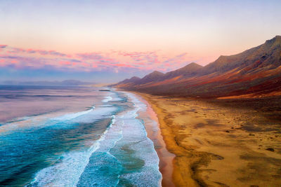 Panoramic view of beach against sky during sunset