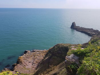 Rock formations by sea against sky