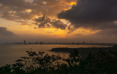 Scenic view of sea against orange sky