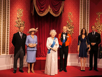 Full length of a young woman standing against the wall