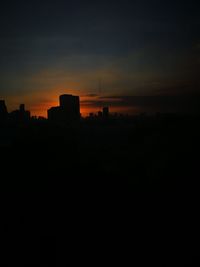 Silhouette buildings against sky during sunset