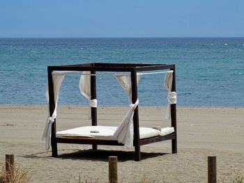 Large luxurious sun bed on beach near estepona in spain against clear sky