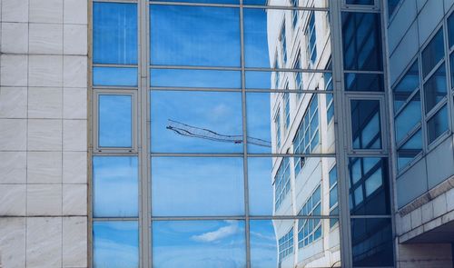 Reflection of ladder on glass building