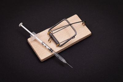 High angle view of book on table against black background