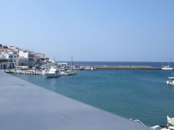 Residential district by sea against clear sky