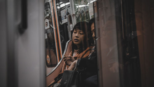 People sitting in train seen through window