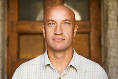 Portrait of bald man against the backdrop of building close-up. model over 40