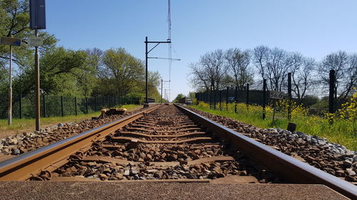 Surface level of railroad tracks against clear sky