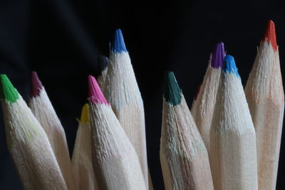 Close-up of multi colored pencils against black background