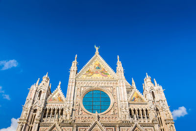 Low angle view of temple building against blue sky