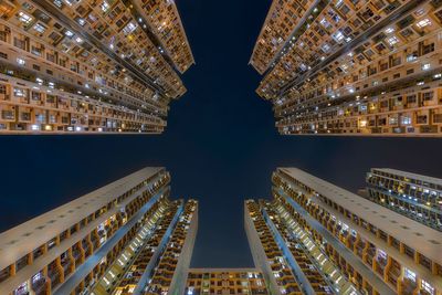 Low angle view of illuminated buildings in city at night