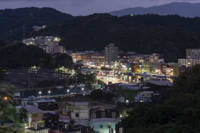 High angle view of illuminated buildings in city at night