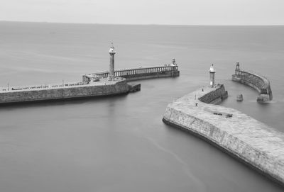 Aerial view of lighthouses in sea against clear sky