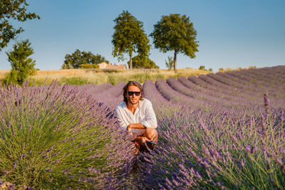 Portrait of young woman standing on field