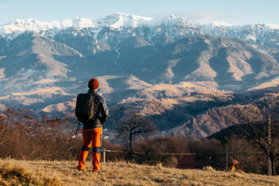 Rear view of man standing on mountain