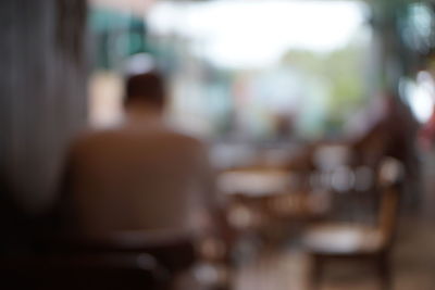 Rear view of man sitting on chair